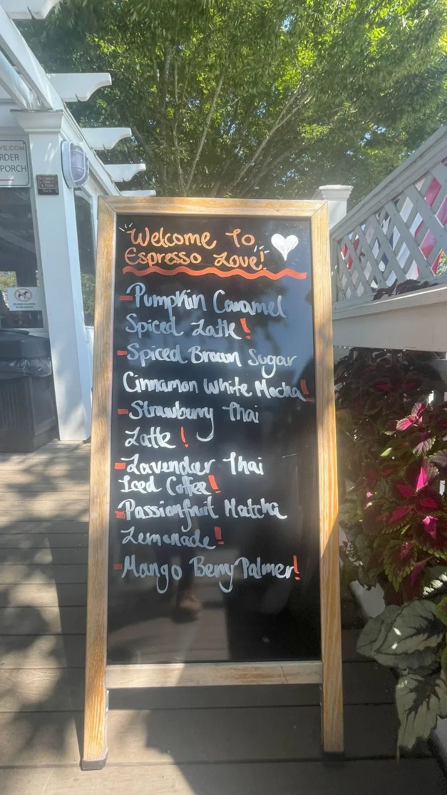 Espresso Love's specials board on the porch, drinks written up in coloured chalk