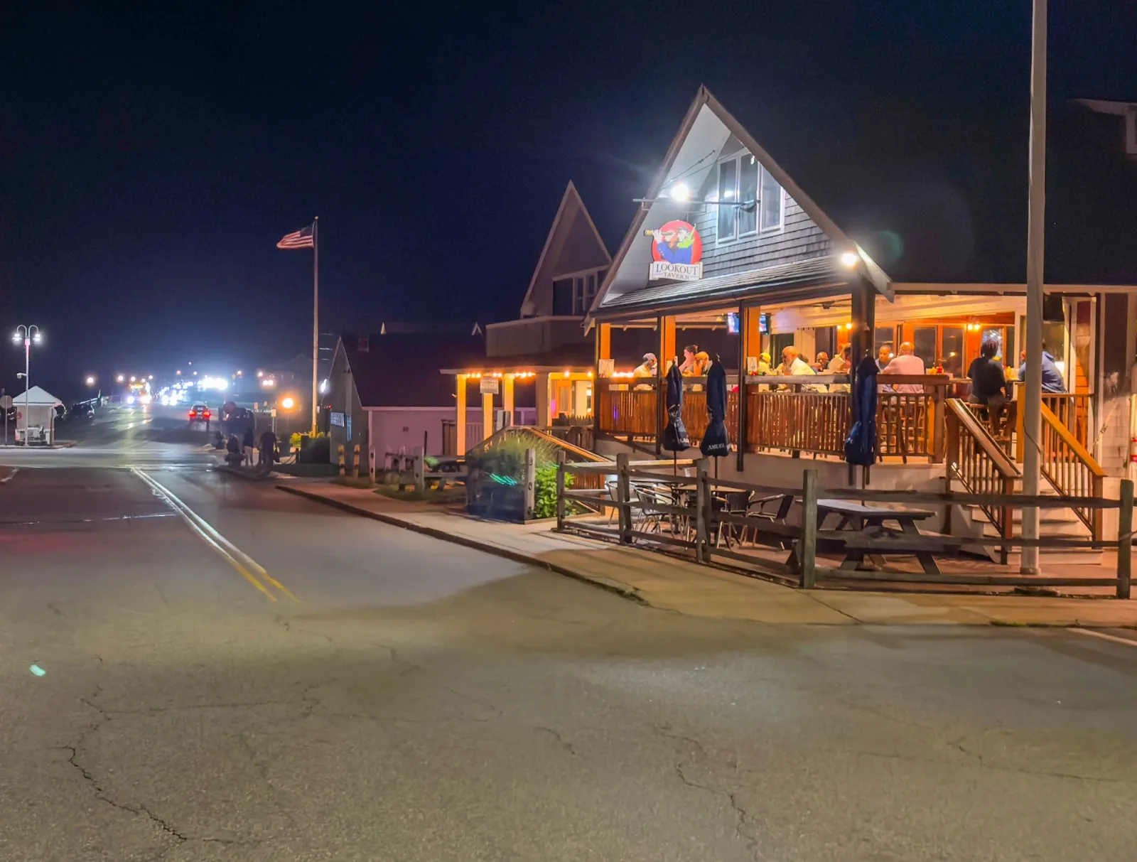 The Lookout Tavern lit up at night, seen down an empty Seaview Avenue