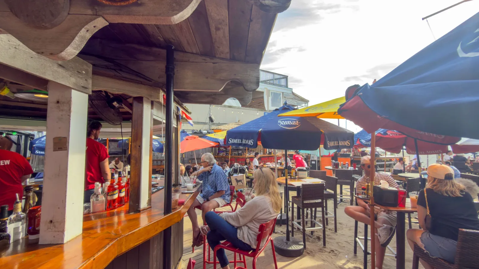 The deck at the Sand Bar in August, every table taken under the umbrellas